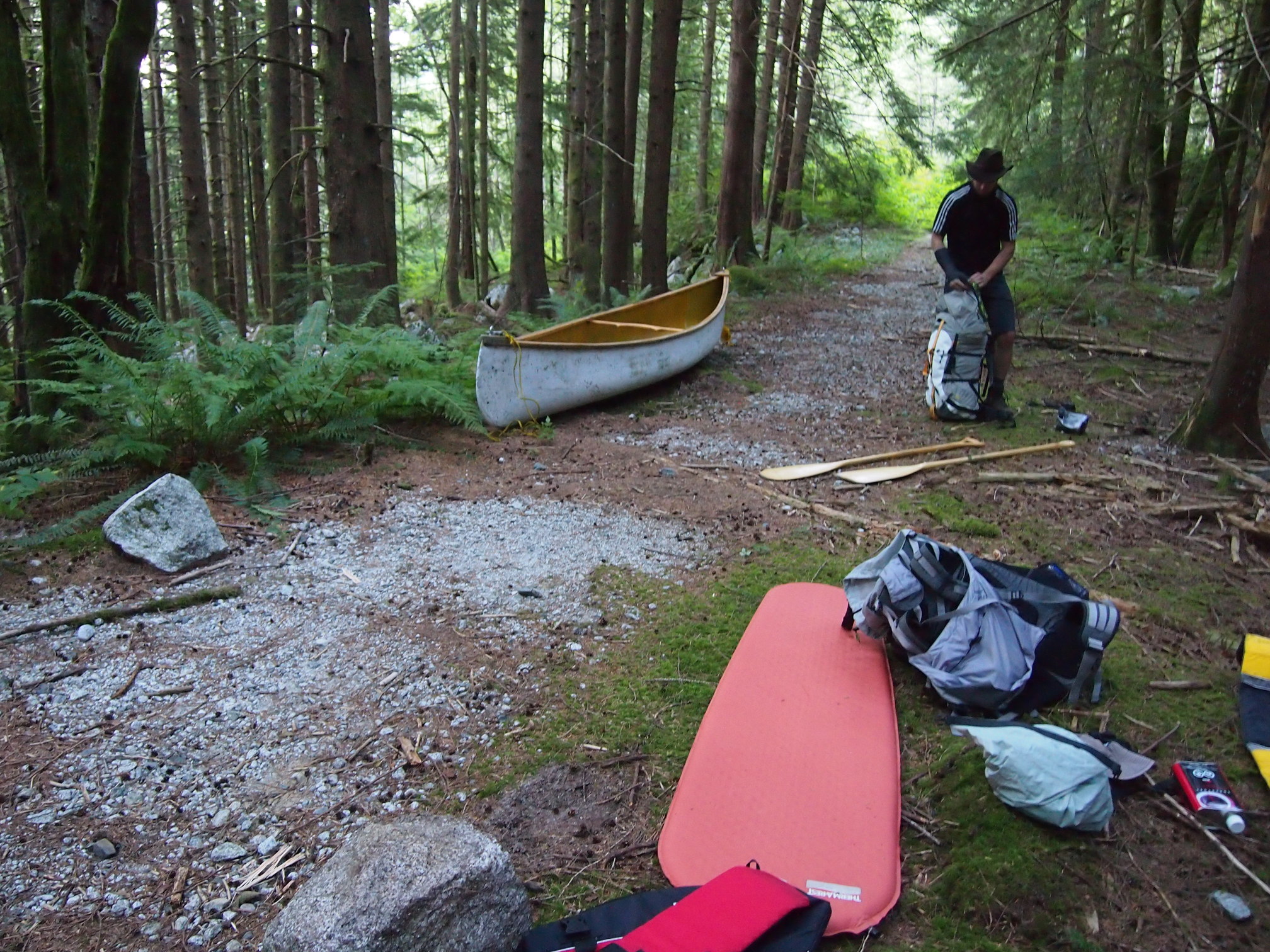 image of canoe and half-packed bivy site