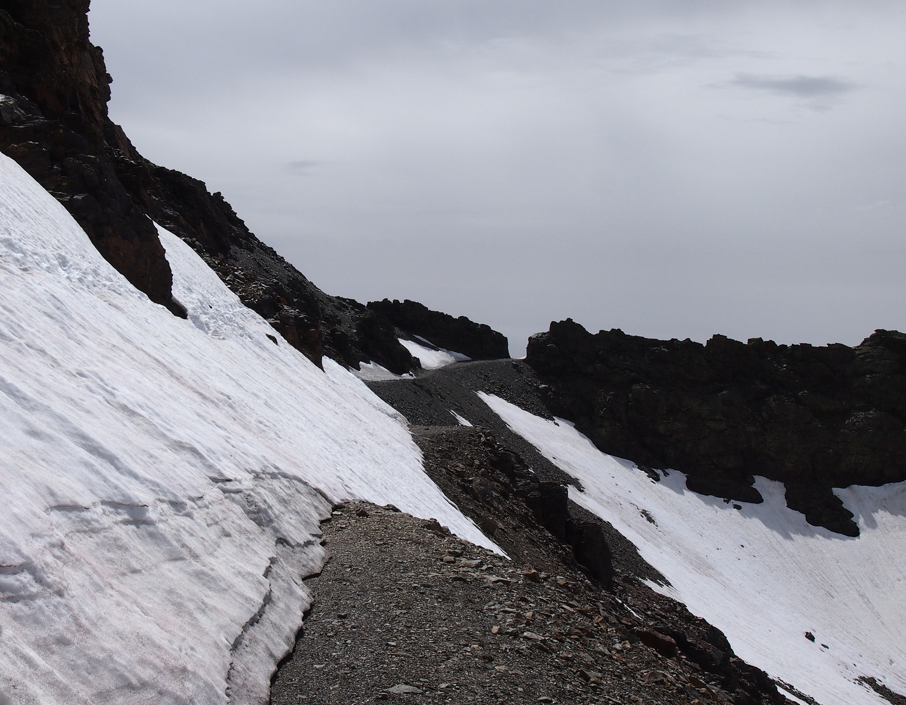 steep snow covering the mountain road