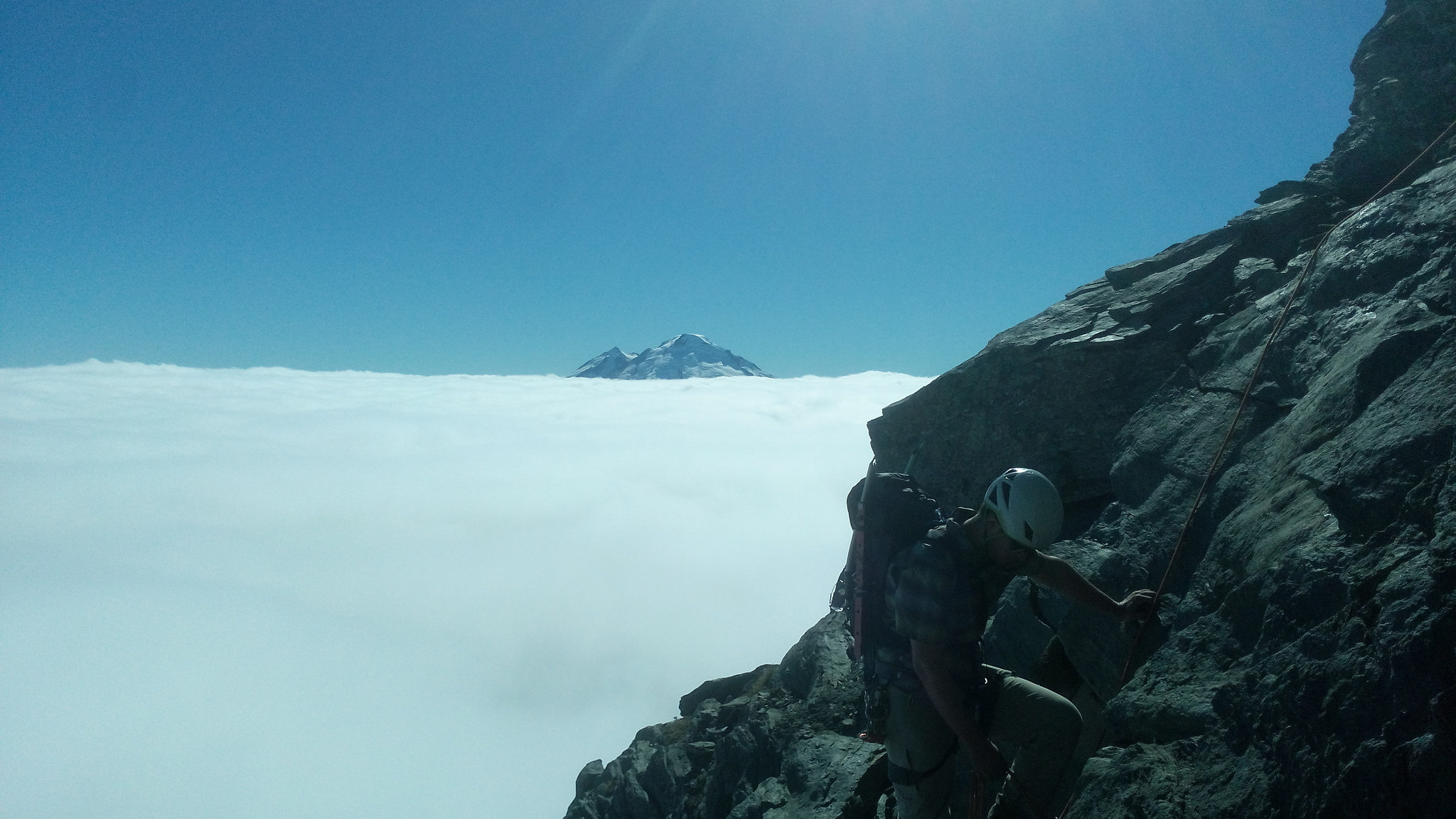 Climbing on some rock with Mt Baker in the background